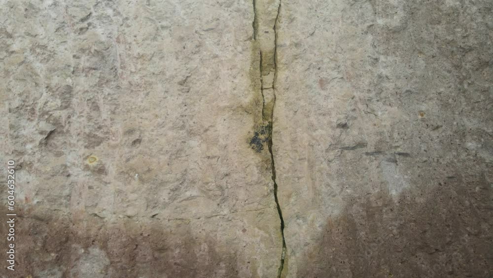 Tracking shooting of crack with deep fault on the rock wall. Earthquake Fault. Close up of a fault line or fracture in the earth in rock Tracking shooting of crack with deep fault on the rock wall. Earthquake Fault. Close up of a fault line or fracture in the earth in rock