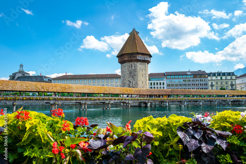 Lucerne, Switzerland - July 10, 2022: View of the Chapel Bridge in historic city of Lucerne, Switzerland. One of the main tourist attractions in the city center.