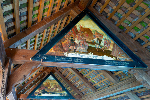 Switzerland travel- Chapel Bridge triangle Renaissance style 17 century artwork . The Art hangs under the gable roof of the 14th century Pedestrian bridge
