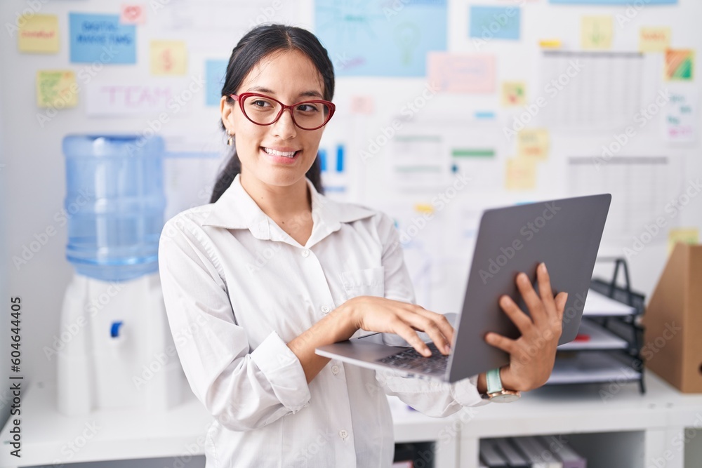 Young beautiful hispanic woman business worker using laptop working at office Young beautiful hispanic woman business worker using laptop working at office