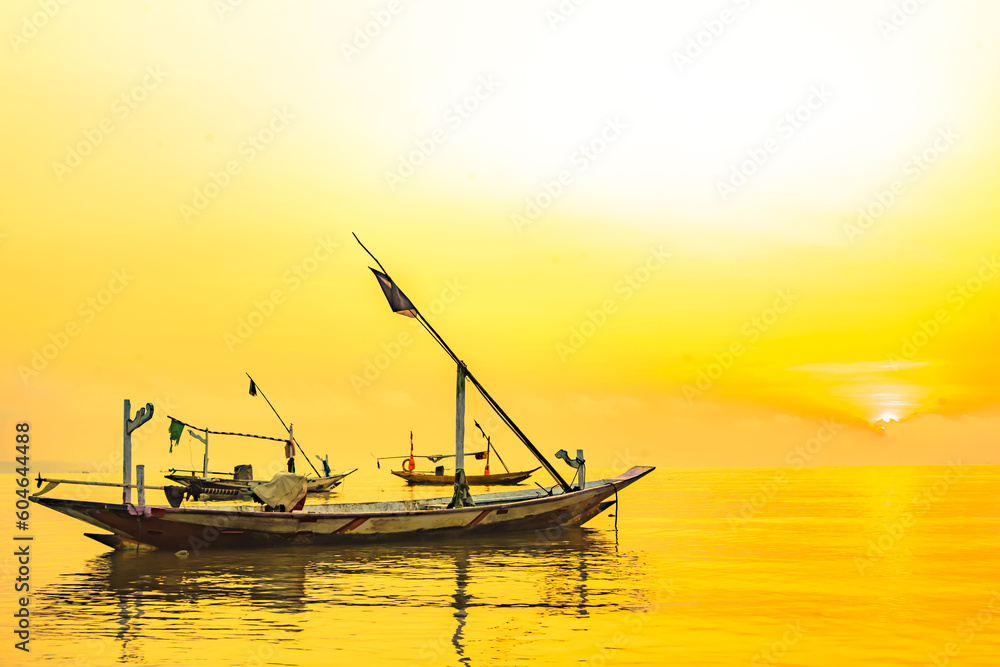 Moored boats during sunrise with yellow sky in Kenjeran, Surabaya, Indonesia. Moored boats during sunrise with yellow sky in Kenjeran, Surabaya, Indonesia.