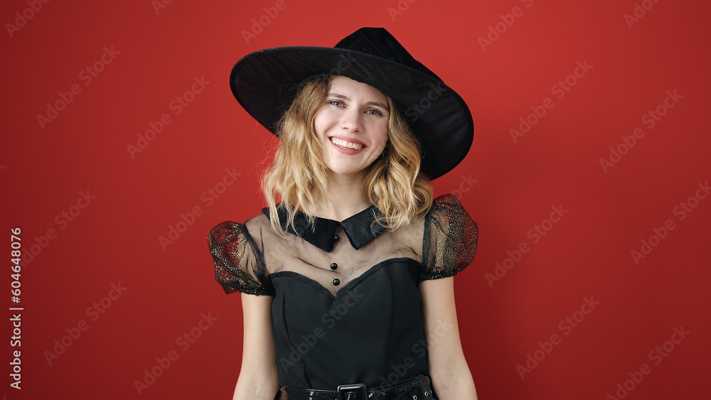 Young blonde woman wearing witch costume using smartphone over isolated red background Young blonde woman wearing witch costume using smartphone over isolated red background