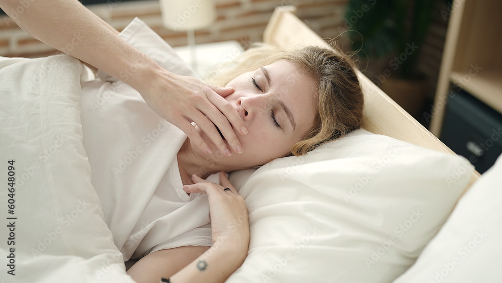 Young blonde woman lying on bed yawning at bedroom Young blonde woman lying on bed yawning at bedroom