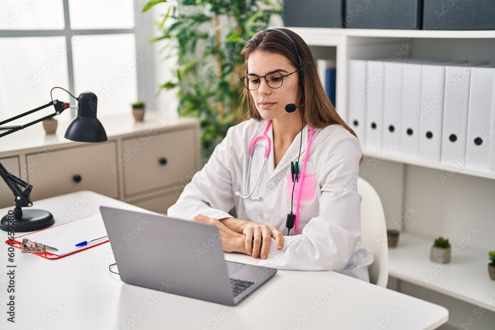Beautiful doctor woman working on online appointment thinking attitude and sober expression looking self confident Beautiful doctor woman working on online appointment thinking attitude and sober expression looking self confident