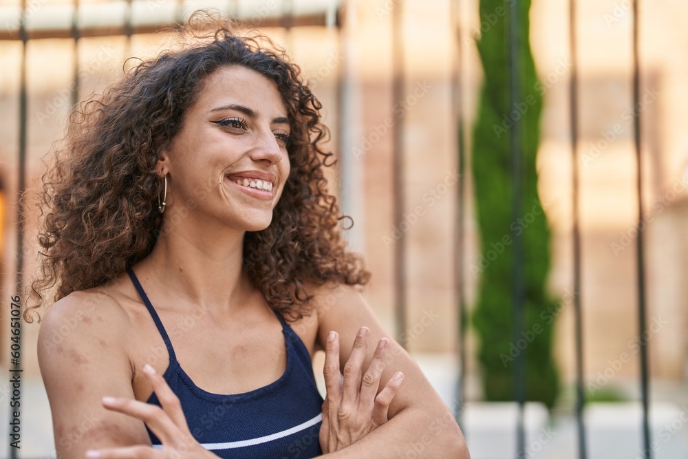 Young beautiful hispanic woman standing with arms crossed gesture at street Young beautiful hispanic woman standing with arms crossed gesture at street