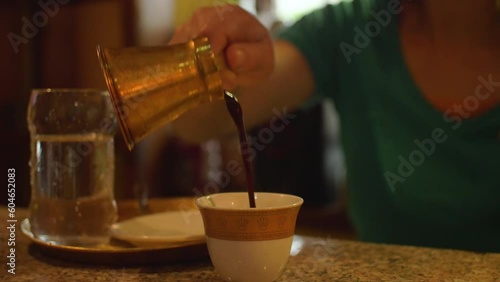 A barista serves Turkish coffee in a restaurant, in Bosnia