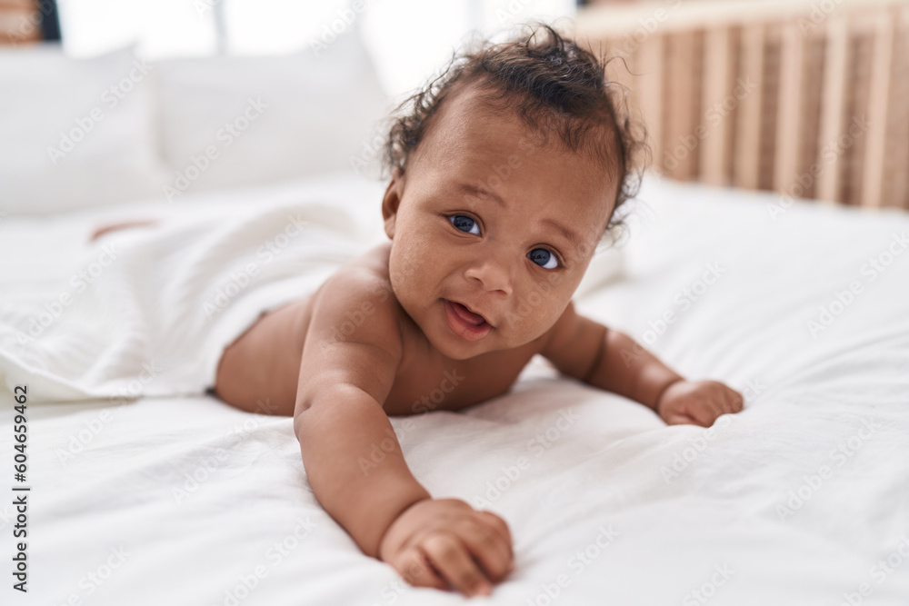African american baby relaxing on bed at bedroom African american baby relaxing on bed at bedroom