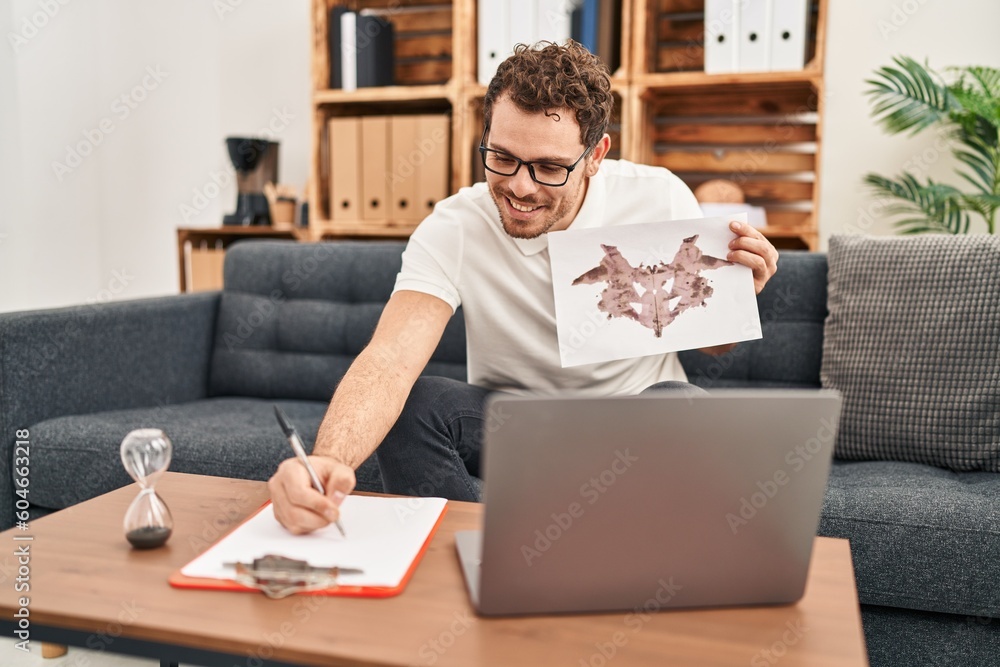 Young hispanic man having online rorschach test at psychology center Young hispanic man having online rorschach test at psychology center
