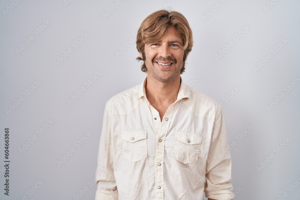 Middle age man standing over isolated background with a happy and cool smile on face. lucky person. Middle age man standing over isolated background with a happy and cool smile on face. lucky person.