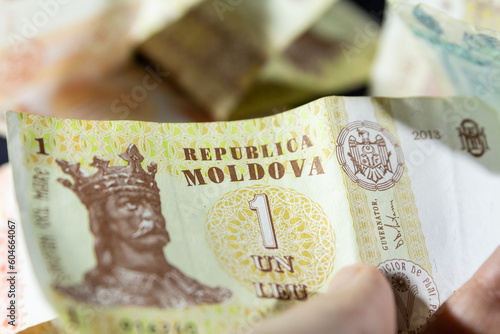 CHISINAU, MOLDOVA - MARCH 1, 2023: Selective blur on banknotes of 1 moldovan leu. The leu, or lei, it is the official currency of the republic of Moldova. photo