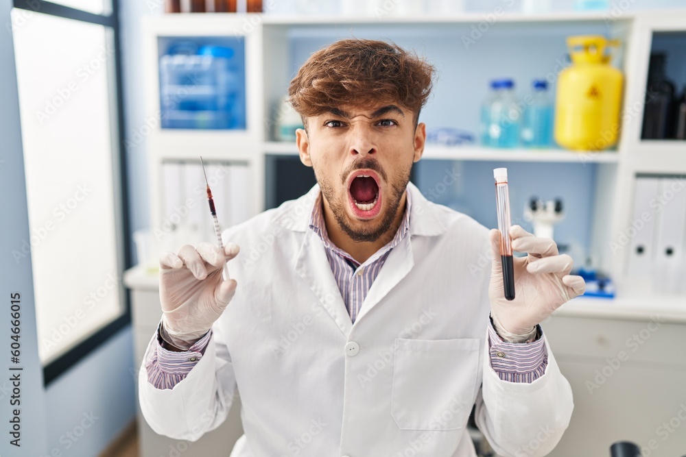 Arab man with beard working at scientist laboratory holding blood ...