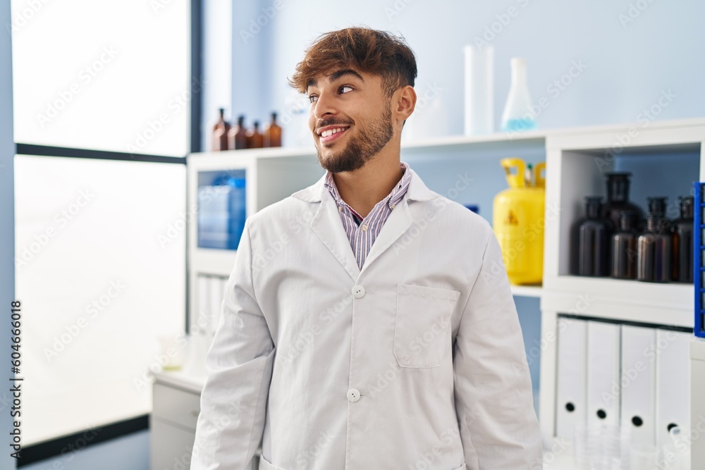 Arab man with beard working at scientist laboratory looking to side, relax profile pose with natural face and confident smile. Arab man with beard working at scientist laboratory looking to side, relax profile pose with natural face and confident smile.
