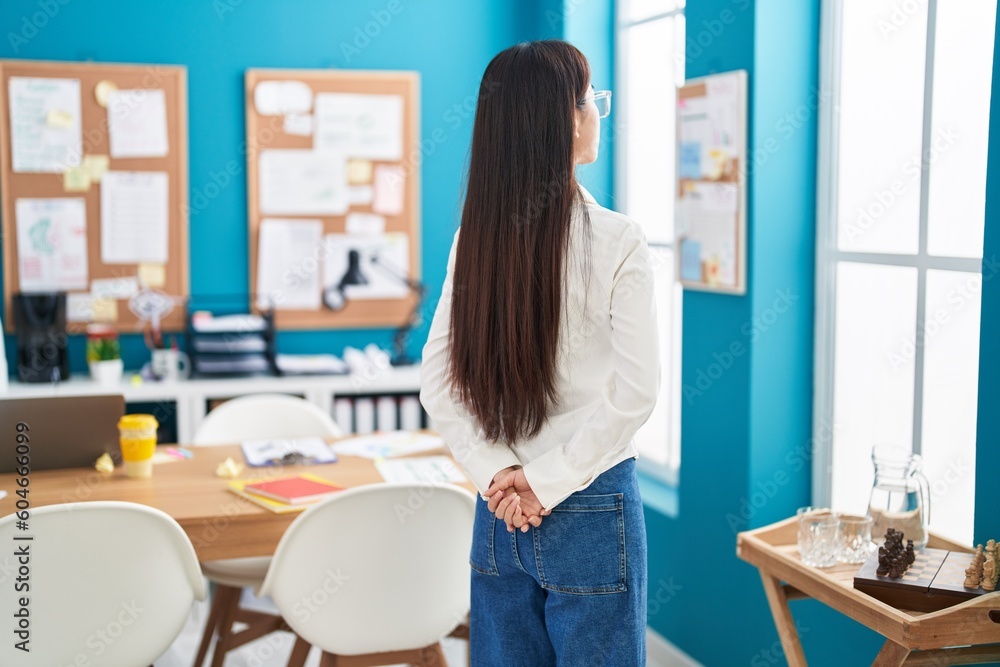 Young chinese woman business worker looking throw the window at office Young chinese woman business worker looking throw the window at office