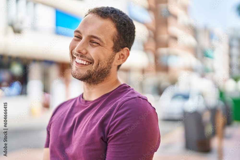 Young man smiling confident looking to the side at street Young man smiling confident looking to the side at street