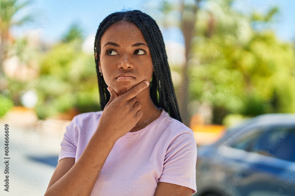 African american woman standing with doubt expression at park