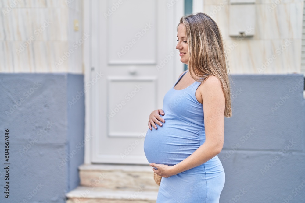 Young pregnant woman smiling confident touching belly at street Young pregnant woman smiling confident touching belly at street