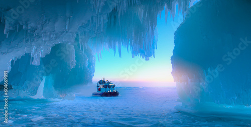 Hovercraft rides on Lake Baikal ice at sunset - Inside the turquoise ice cave - ice cave winter frozen nature background landscape - Lake Baikal, Siberia, Eastern Russia