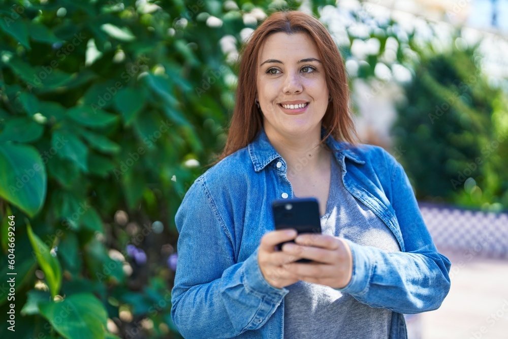 Young beautiful plus size woman smiling confident using smartphone at park Young beautiful plus size woman smiling confident using smartphone at park