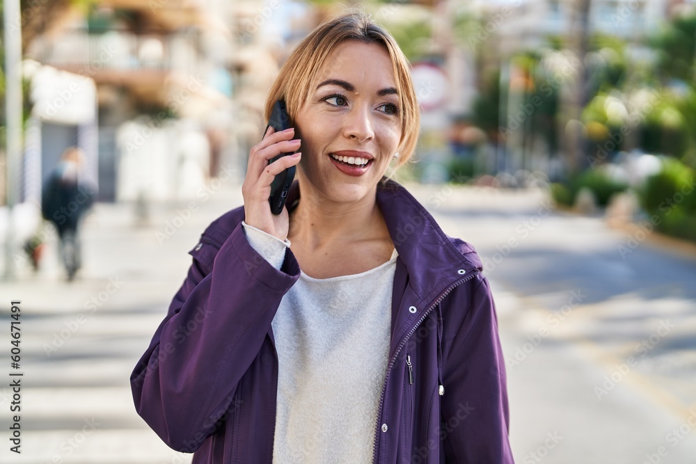 Young woman smiling confident talking on the smartphone at street Young woman smiling confident talking on the smartphone at street