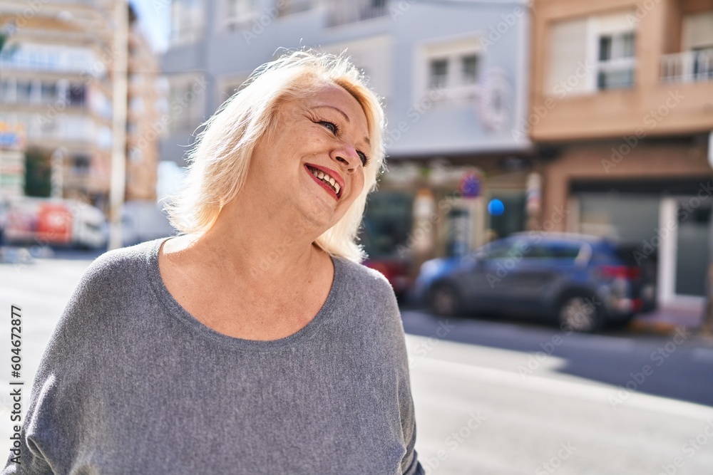 Middle age blonde woman smiling confident standing at street Middle age blonde woman smiling confident standing at street