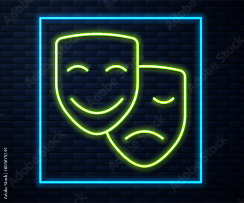 Glowing neon line Comedy and tragedy theatrical masks icon isolated on brick wall background. Vector