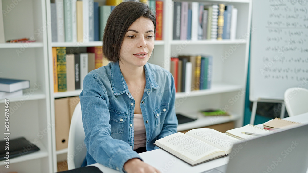 Young caucasian woman student using laptop studying at university classroom Young caucasian woman student using laptop studying at university classroom