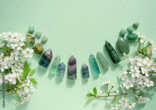 Fotobehang Crystal towers minerals set and white flowers on green abstract background