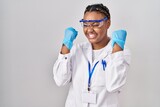 African american woman with braids wearing scientist robe very happy and excited doing winner gesture with arms raised, smiling and screaming for success. celebration concept.