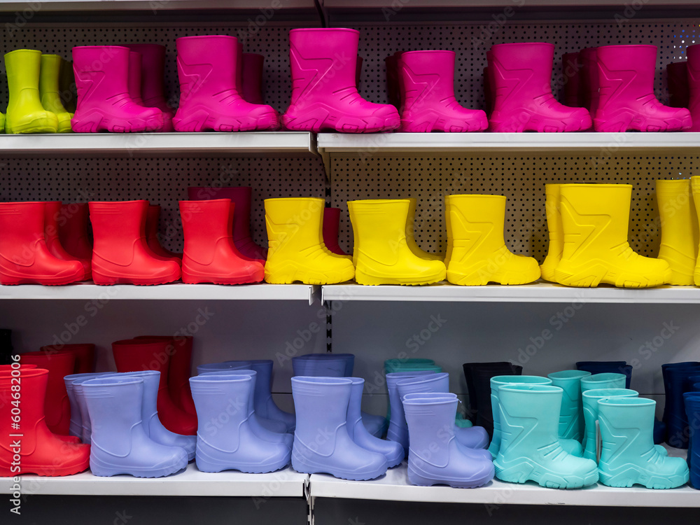 Shelves in the store with rubber boots . Boots of different colors
