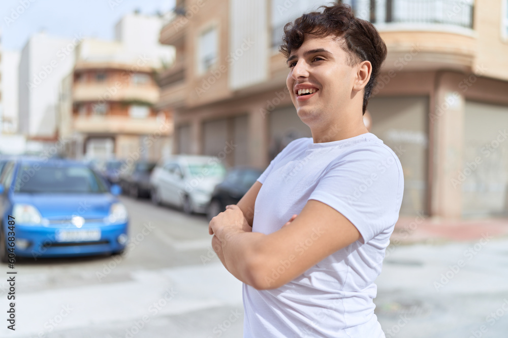 Fototapeta premium Non binary man standing with arms crossed gesture at street