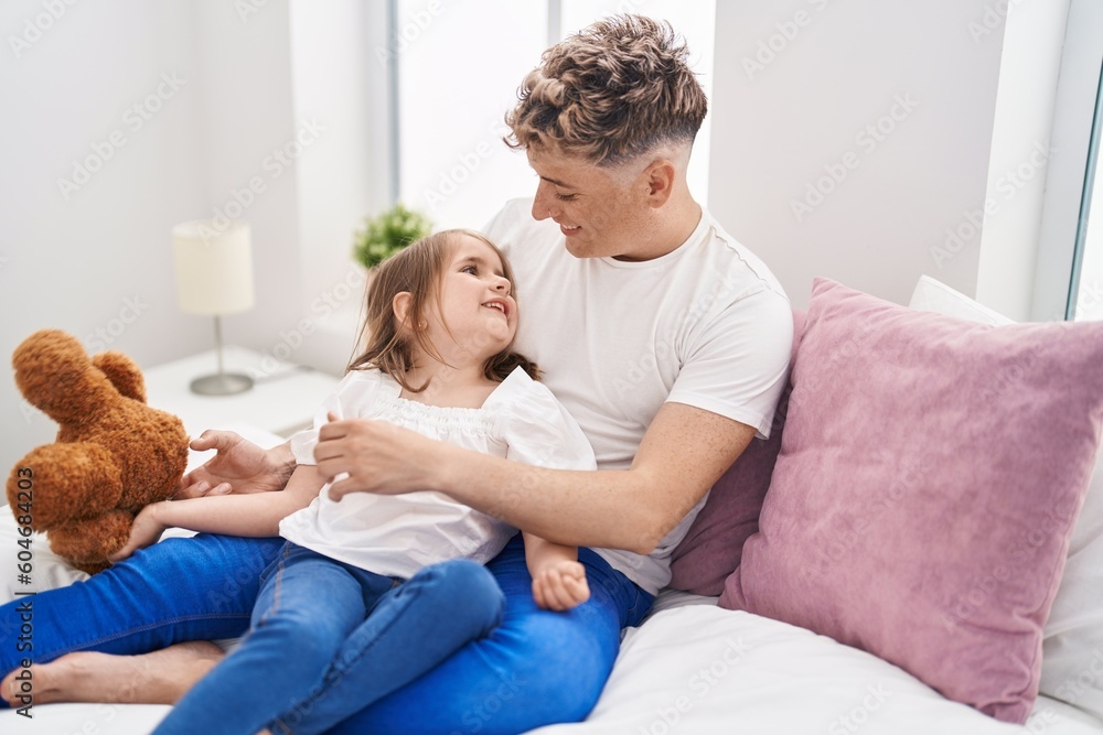 Father and daughter father and daughter hugging each other holding teddy bear at bedroom Father and daughter father and daughter hugging each other holding teddy bear at bedroom