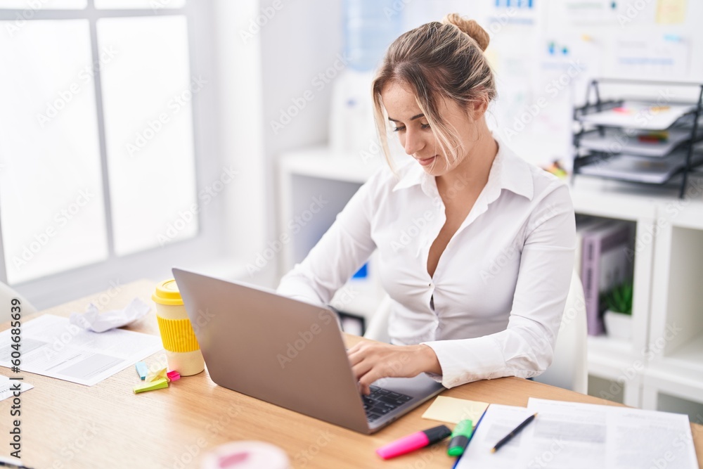 Young blonde woman business worker using laptop working at office Young blonde woman business worker using laptop working at office