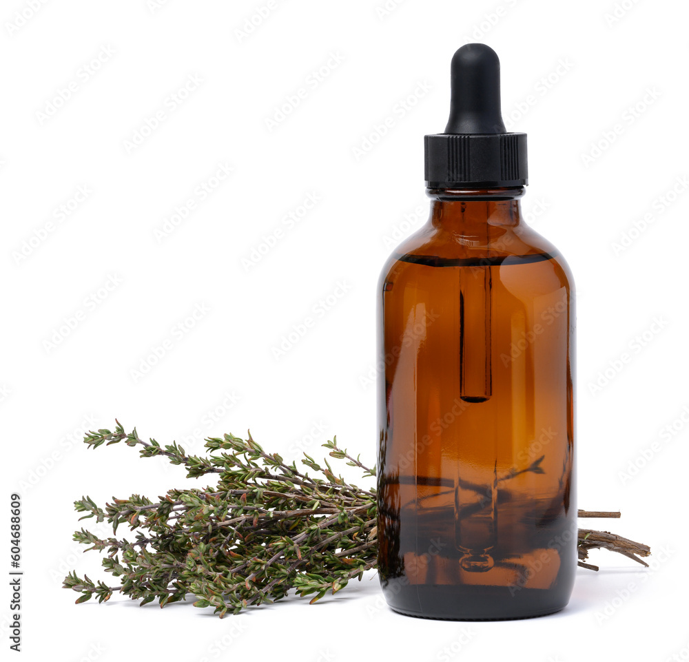 A glass brown bottle with a pipette and a branch of cumin on a white isolated background, a container for oils and essences A glass brown bottle with a pipette and a branch of cumin on a white isolated background, a container for oils and essences