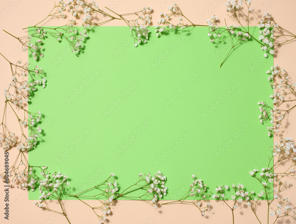 Empty green sheet of paper and gypsophilia flowers, space for an inscription Empty green sheet of paper and gypsophilia flowers, space for an inscription