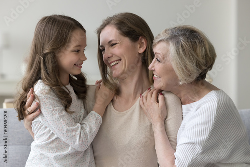 Lovely women hugging showing care feel unconditional love spend priceless time together at home, looking at each other with affection and warmth. Multigenerational family portrait, ties, understanding