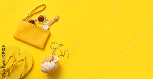 Slika na platnu Stylish bag with seashell and different accessories on yellow background with sp