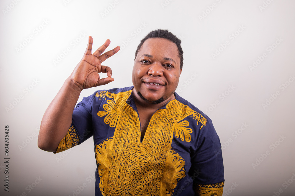 Trans man making an 'Okay' hand sign, isolated person on white background Trans man making an 'Okay' hand sign, isolated person on white background