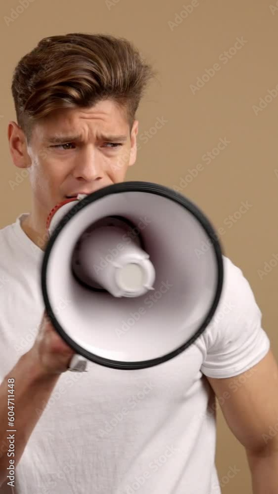 Upset caucasian man yelling using a loudspeaker