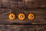 Three ceramic pumpkin on woden table. Halloween, harvest