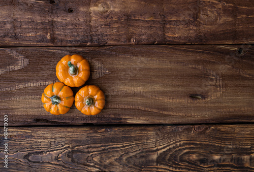 Three ceramic pumpkin on woden table. Halloween, harvest