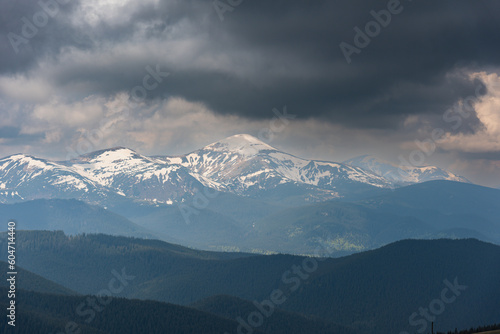 A trip through the spring mountains with a view of snow-capped peaks