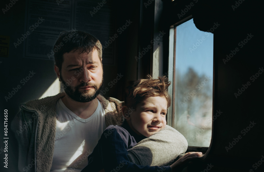 father and child sitting by the window in train. Travel concept father and child sitting by the window in train. Travel concept