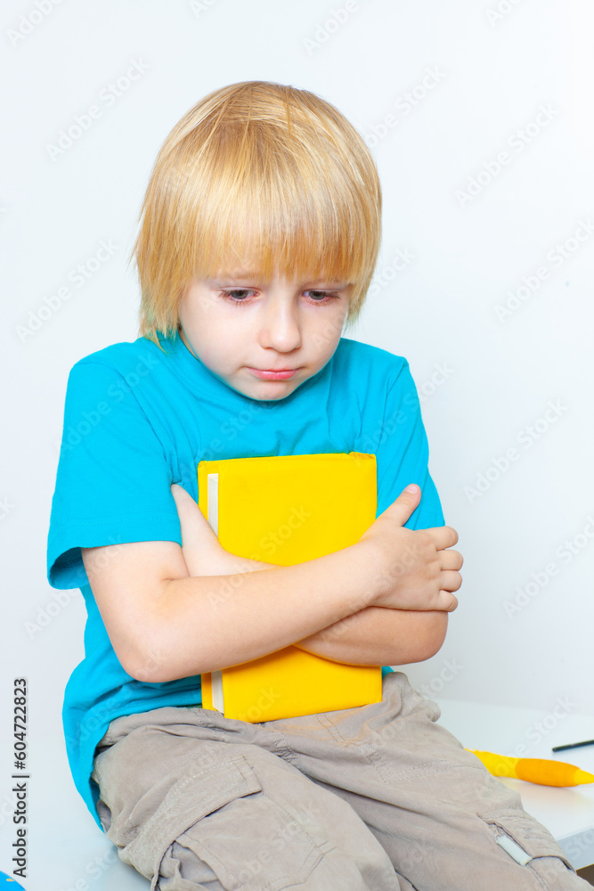 little boy with a book on a light background little boy with a book on a light background