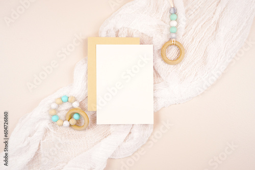 5x7 greeting card party invitation product mockup. Baby shower 1st birthday Christening gender neutral party. Styled against a boho Scandi theme beige and white background. Negative copy space.
