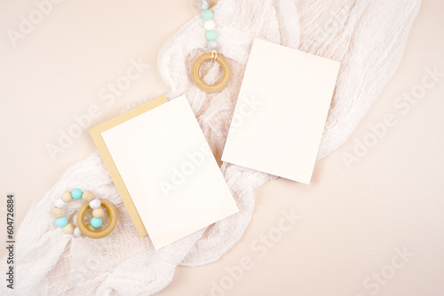 Two 5x7 greeting card party invitation product mockup. Baby shower 1st birthday Christening gender neutral party. Styled setting. Boho Scandi theme beige and white background. Negative copy space.