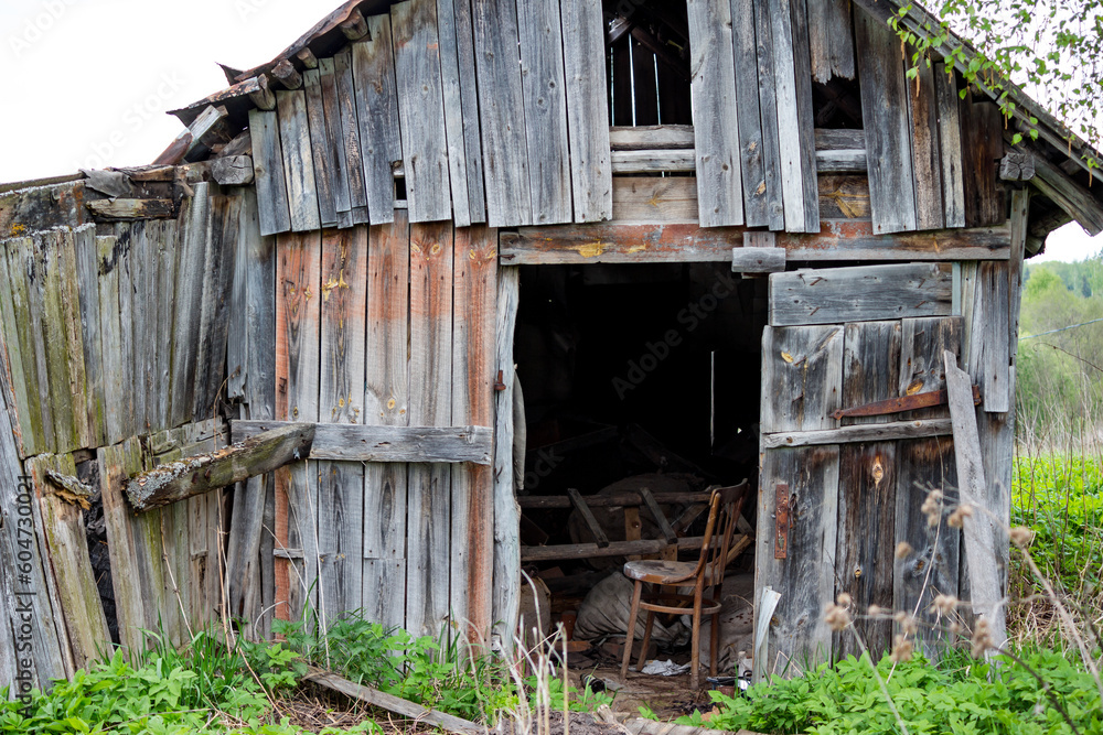 Old wooden rustic barn with various junk inside Old wooden rustic barn with various junk inside