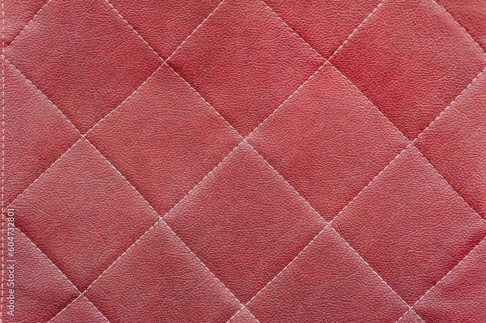 Fototapeta premium Texture, background of red natural leather sofa, wall.