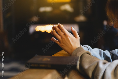 Fotografia Woman praying on her knees in an ancient Catholic temple to God