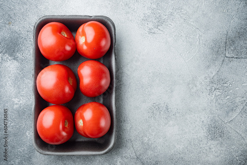 Fresh red organic tomatoe, on gray background with copy space for text