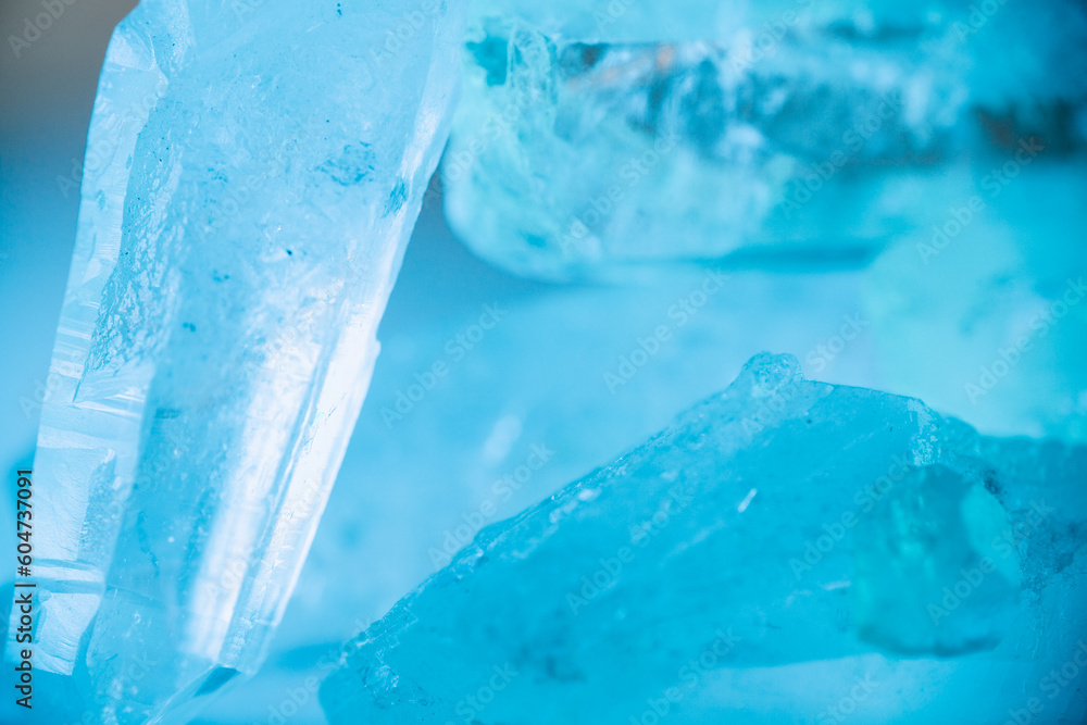 gemstone texture in blue light.transparent quartz crystals background in blue tones.crystals of natural transparent stone rock.Texture of natural stone Rock crystal gemstone texture in blue light.transparent quartz crystals background in blue tones.crystals of natural transparent stone rock.Texture of natural stone Rock crystal